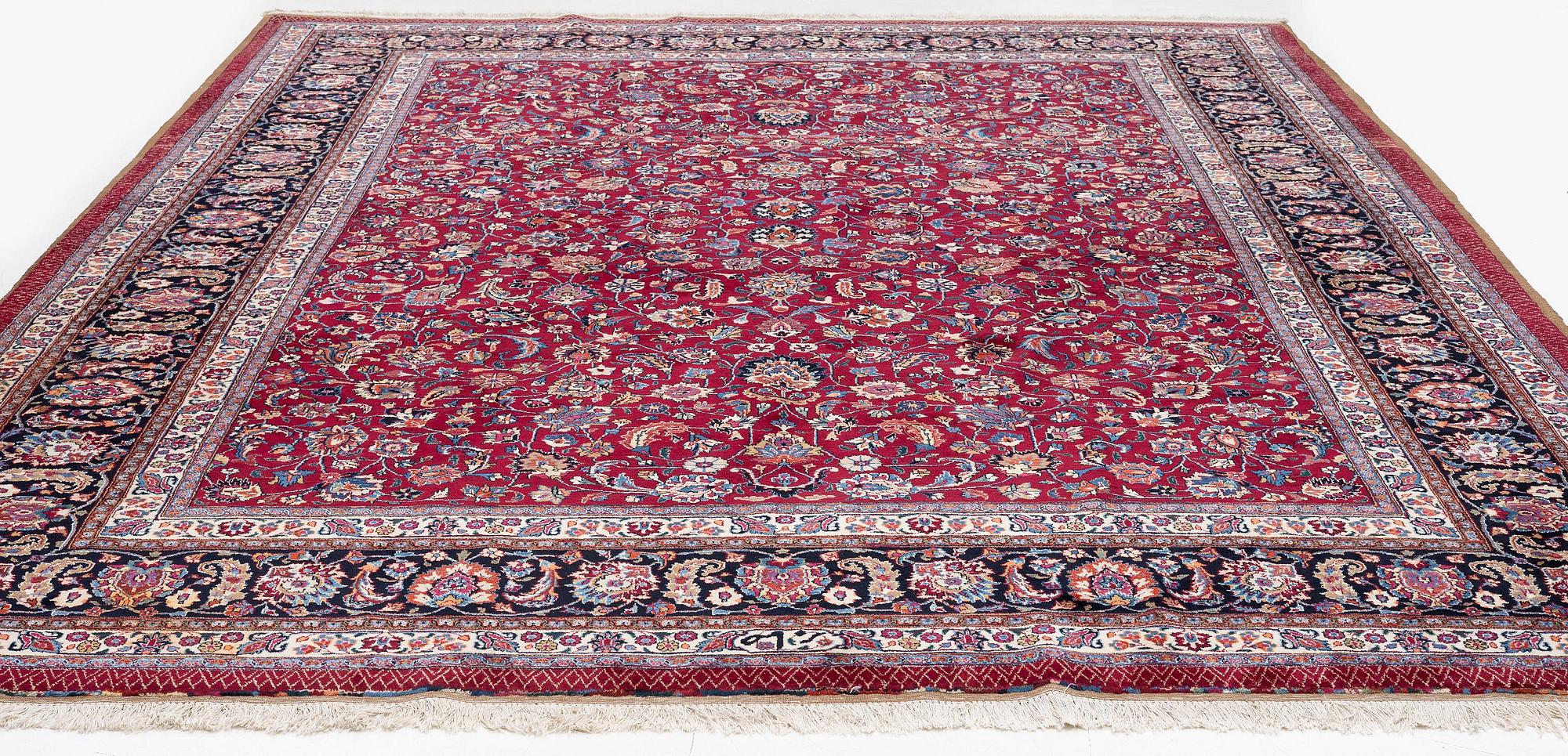 A Mashad carpet, signed Saber, c. 402 x 299 cm.