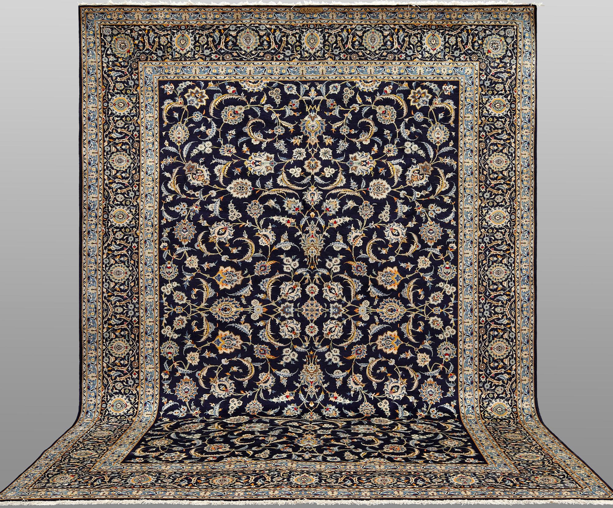 A Keshan carpet, signed, approx. 430 x 320 cm.