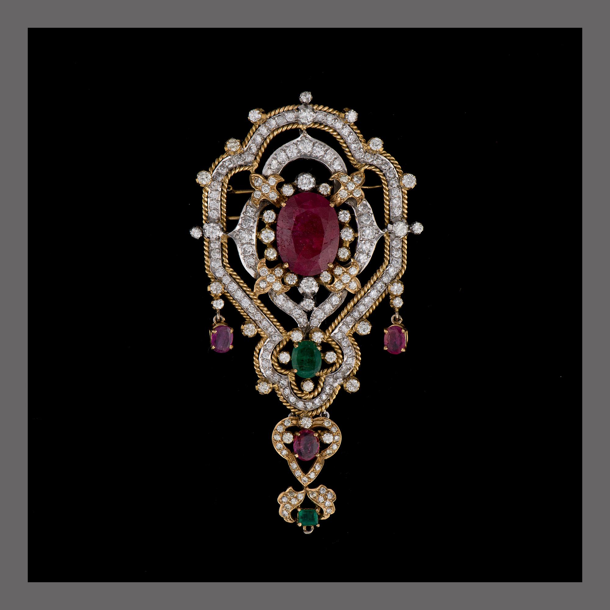 A BROOCH / PENDANT, 18K white and yellow gold, rubies, emeralds, diamonds. Iran. Weight c. 42,6 g.