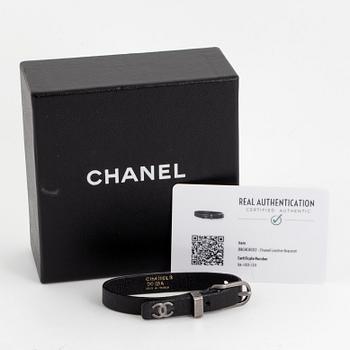 CHANEL, a leather bracelet.