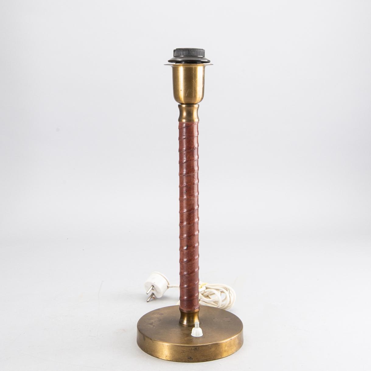 A Swedish brass and leather lamp around 1950.