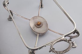 A silvered metal serving dish with rechaud, first half of the 20th century.