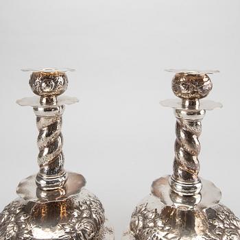 A pair of silver baroquestyle candlesticks. W.H.H, Stockholm. 1935. Filled foot.