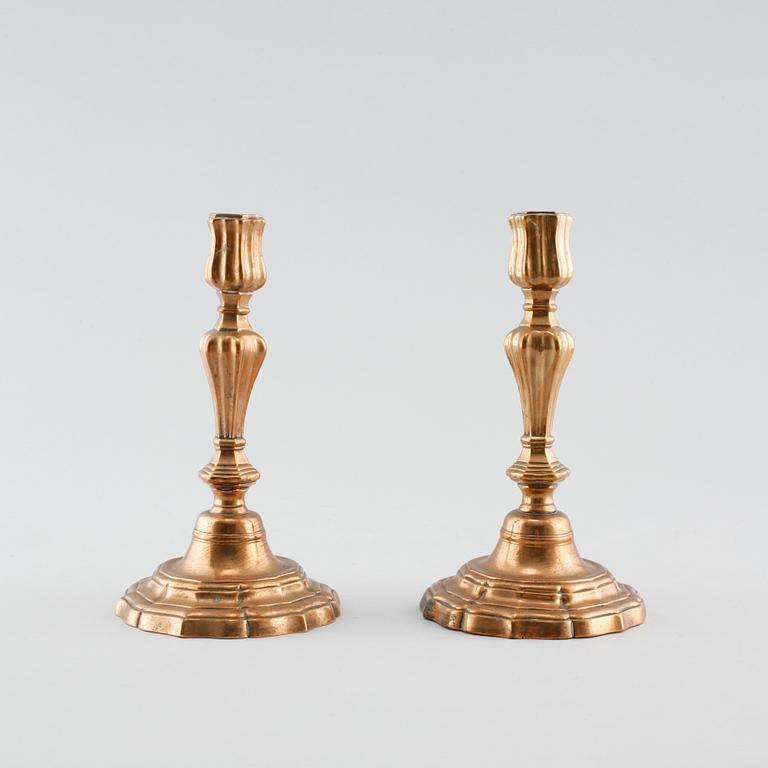 A pair of late barouqe bronze candlesticks, 18th century.