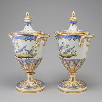 A pair of French 19th century porcelaine 
lidded vases with Sèvres style mark.