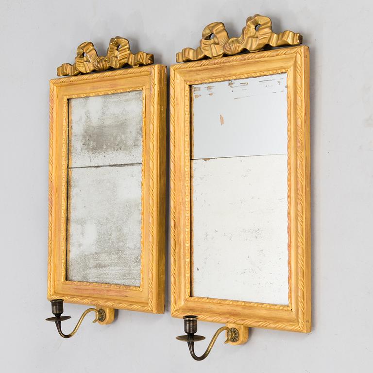 A pair of mirrored wall sconces from the latter half of the 20th century.