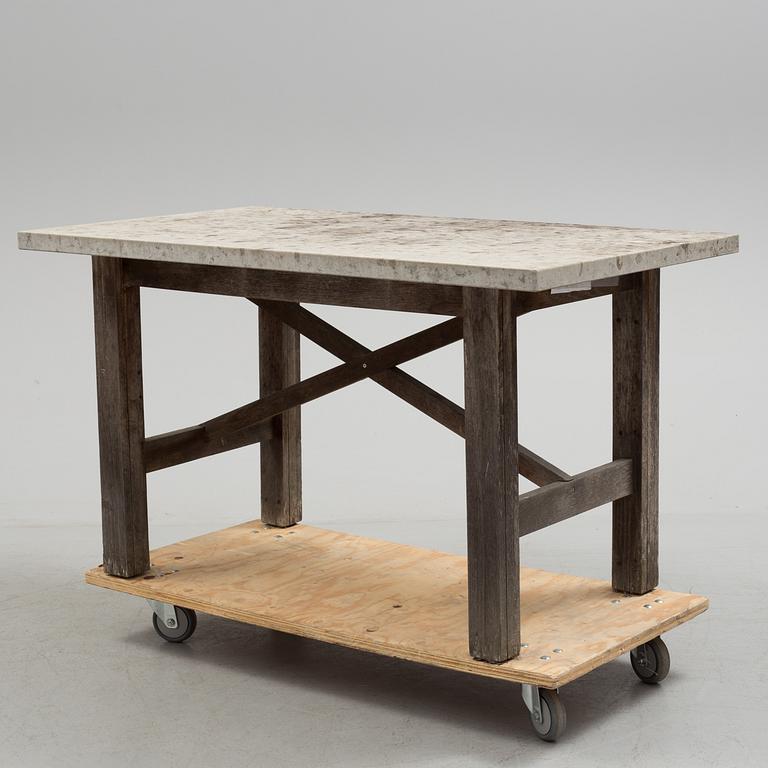 A Limestone and wood table.