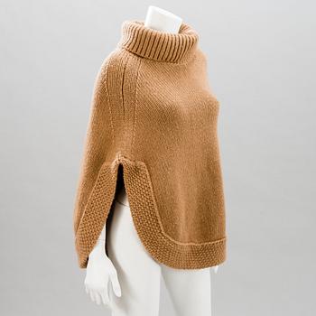 GUCCI, CAMEL HAIR PONCHO AND A HAT.