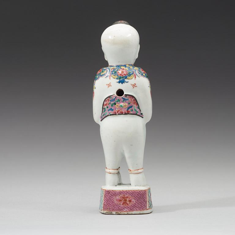 A famille rose figure of a boy, Qing dynasty, 18th Century.