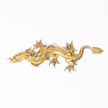 A Chinese bronze dragon fitting, late Qing dynasty.