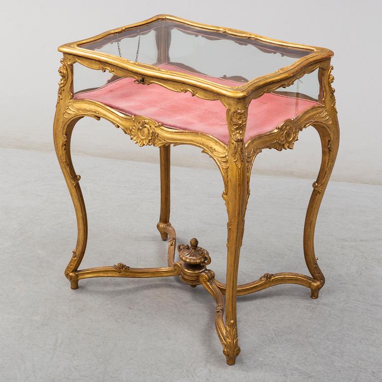 A Louis XV style display table, first half of the 20th century.