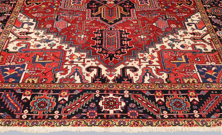 A semi-antique Heris carpet, approx. 343 x 260 cm.