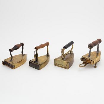 A set of four Swedish brass irons, 18th/19th Century.