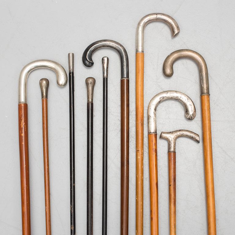 NINE WALKING STICKS, silver handles and a stick with plate handle, first half of the 20th century.