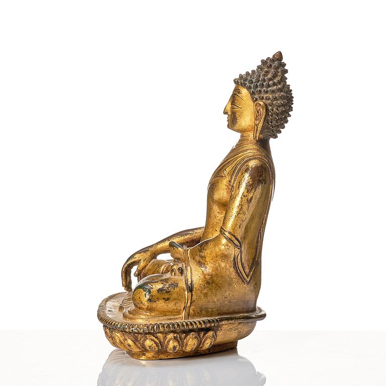 A gilt copper alloy figure of buddha, Nepal, 18th Century.