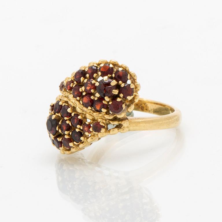 An 18K gold ring with garnets.