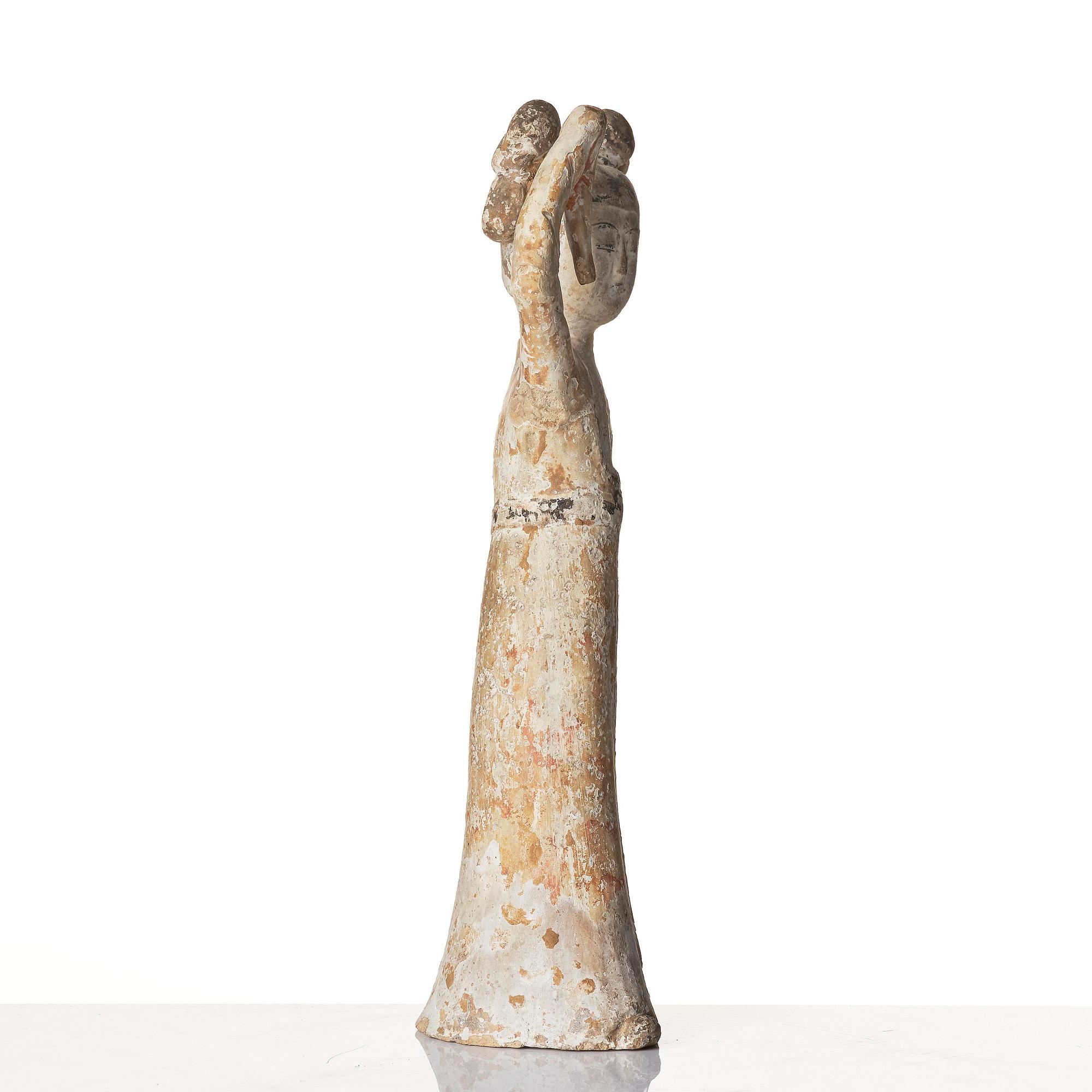 A painted pottery figure of a female dancer, Tang dynasty (608-906).