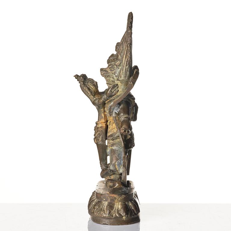 A bronze deity and a brass sacrificial bowl, Tibet, circa 1900.