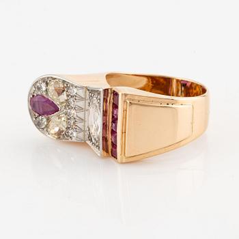 An 18K gold and platinum ring set with rubies and old-cut diamonds.
