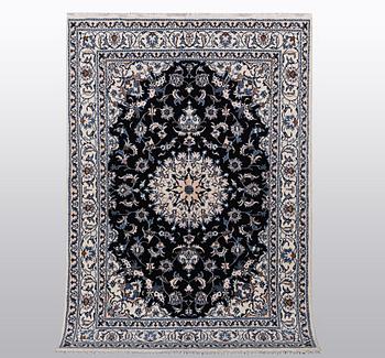 A rug, Nain, part silk, ca 242 x 167 cm.