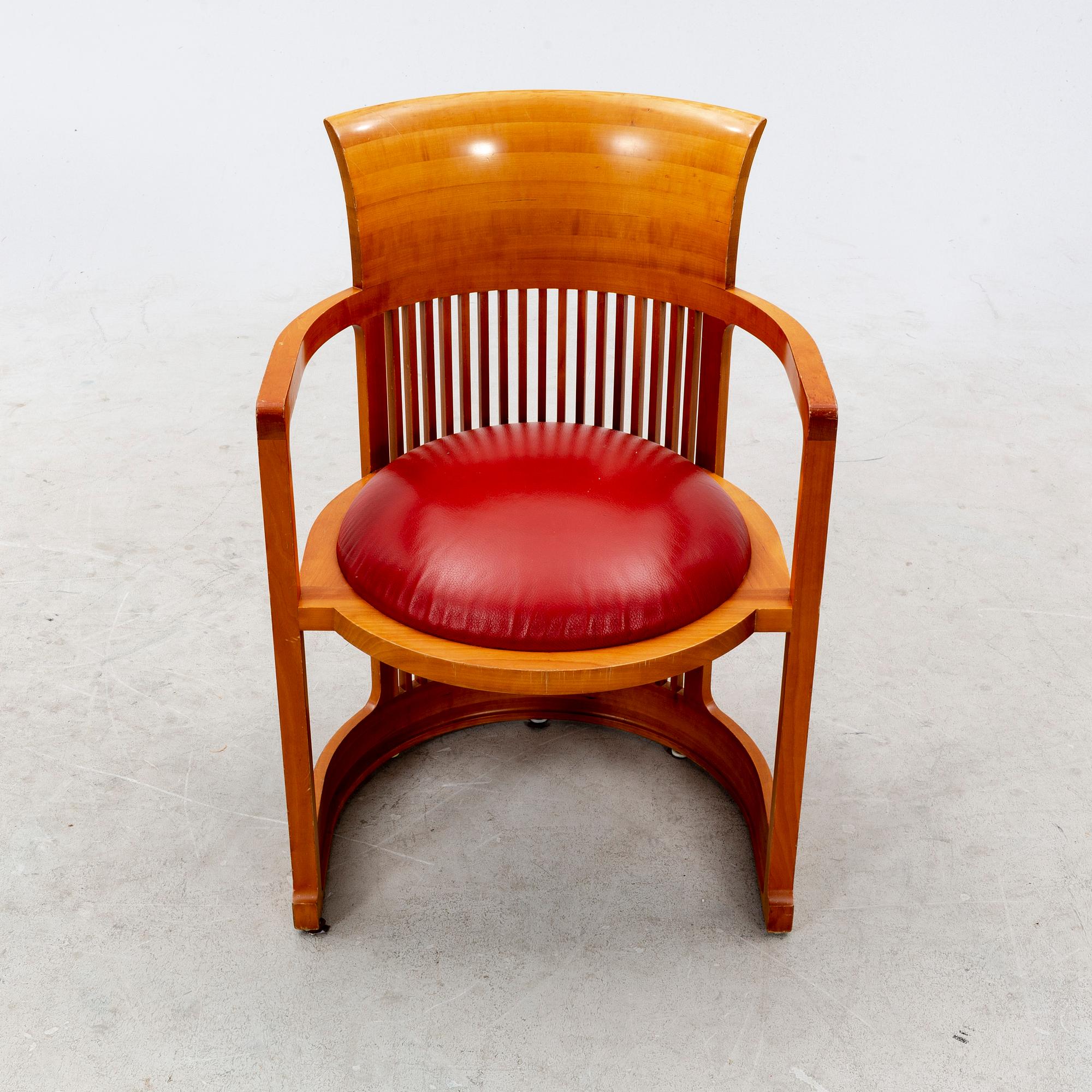 A cherry wood model 606 'Barrel' chair by Frank Lloyd Wright from Cassina.