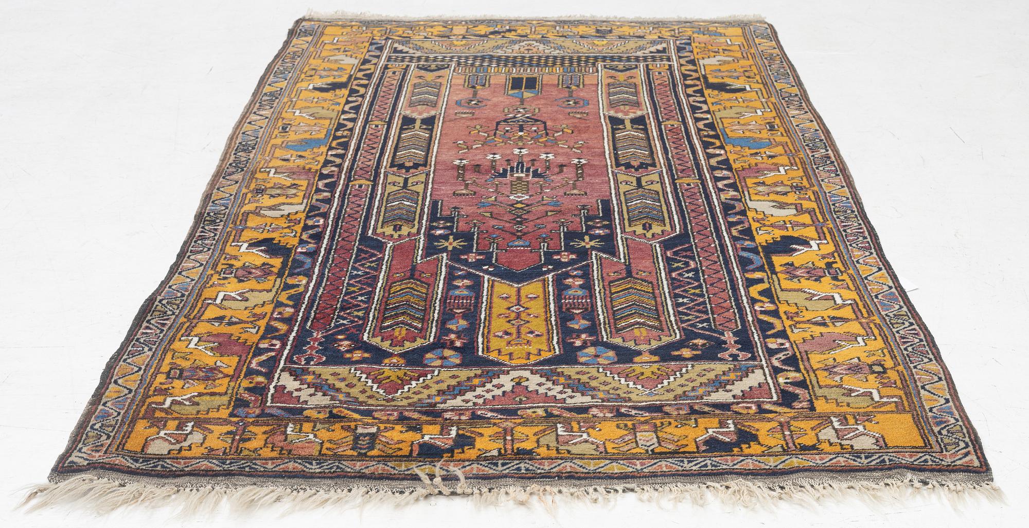 An Anatolian prayer rug, semi-antique, c. 205 x 115 cm.