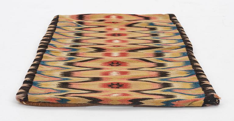 A carriage cushion, double-interlocked tapestry, ca 46 x 96 cm, Scania, mid 19th century.