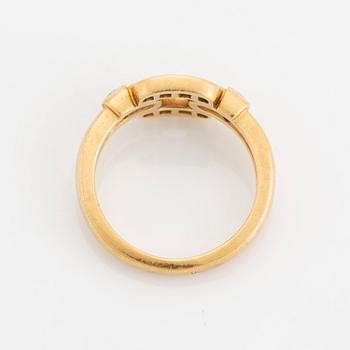 An 18K gold Cartier ring set with round brilliant-cut diamonds.