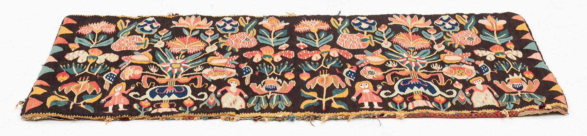 A carrige cushion, "Urnor och par", tapestry weave, ca 102 x 48,5 cm, around the years 1800-1830.