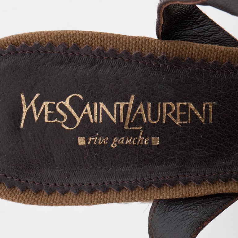 YVES SAINT LAURENT, a pair of straw and leather wedge sandals.