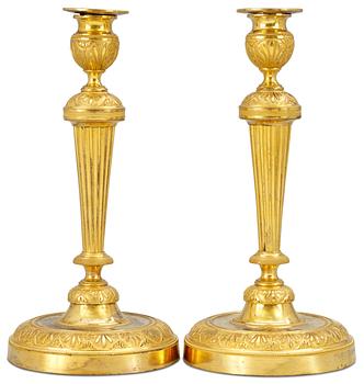 1040. A pair of Empire candlesticks.