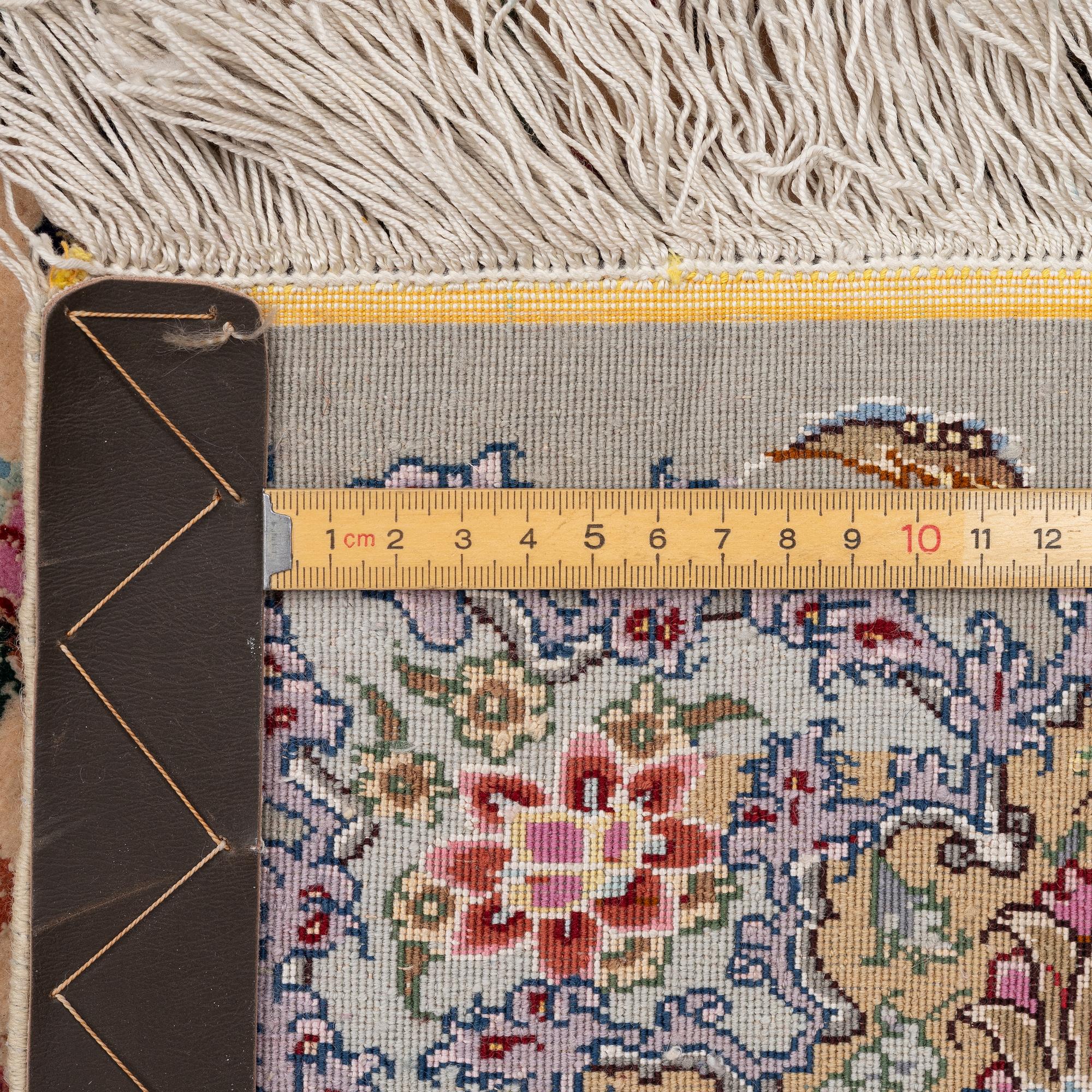 A Tabriz carpet, part silk, approx. 367 x 250 cm.
