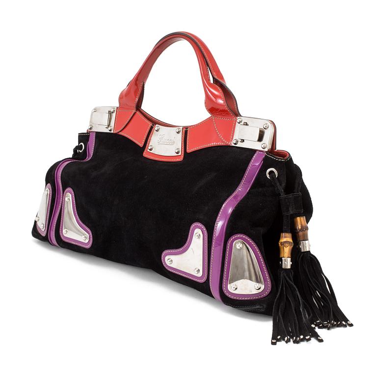 A black suede handbag by Gucci.