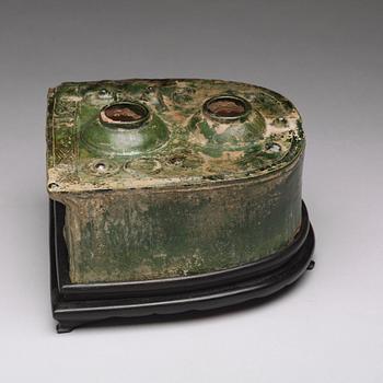 A green glazed pottery model of a stove, Han dynasty (206 BC-220 AD).