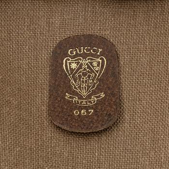 Gucci, a canvas weekend bag.