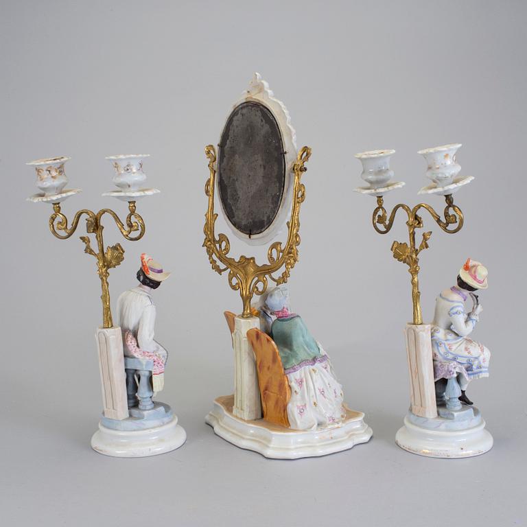 A late 18th century porcelain and biscuit toilette mirror and pair of candelabrar.
