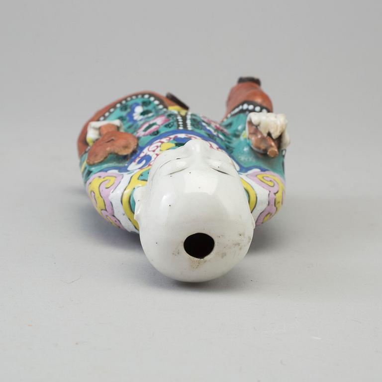 A porcelain figure of a laughing boy, Qing dynasty, 19th Century.