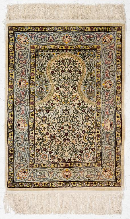 A silk Hereke rug, Turkey, approx. 82 x 58 cm.