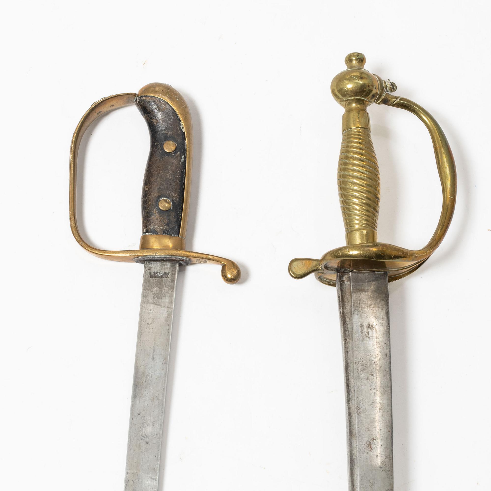 A Swedish police sabre and cutlass, with scabbards.