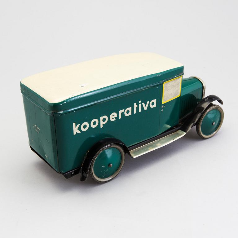 A tinplate biscuit jar in the shape of a truck 1930s.