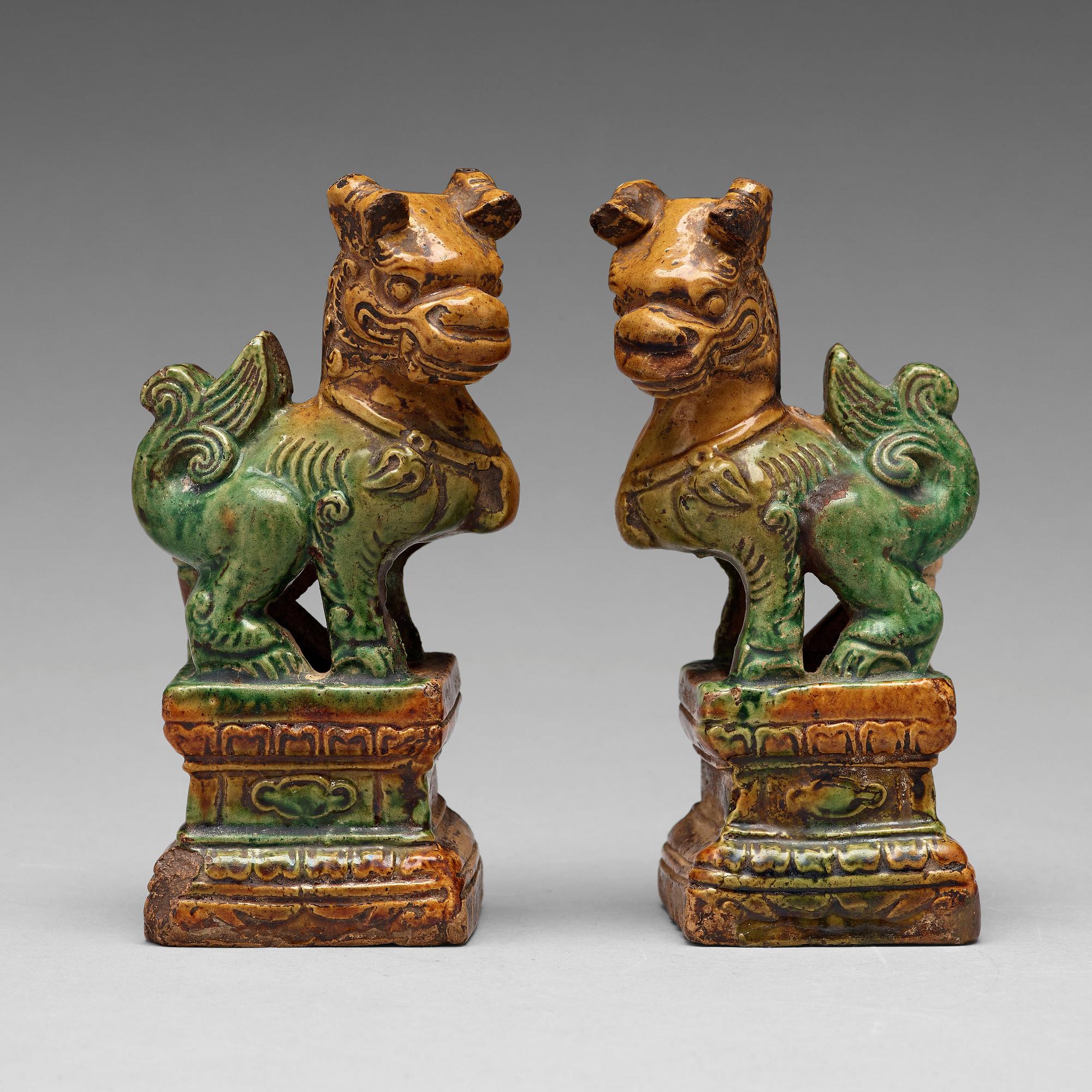 A pair of green and yellow glazed joss stick holders, Ming dynasty (1368-1644).