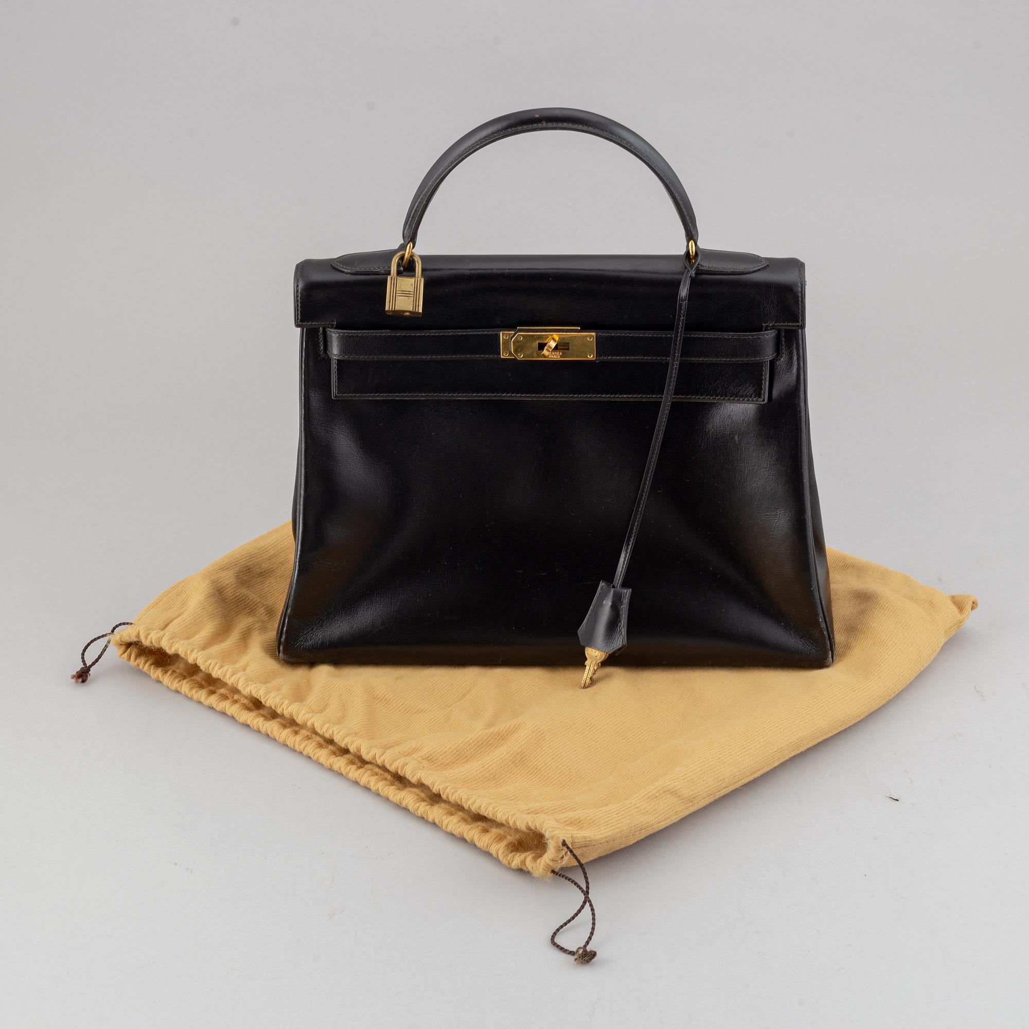 Hermès,a black leather 'Kelly 32' handbag, 1975.