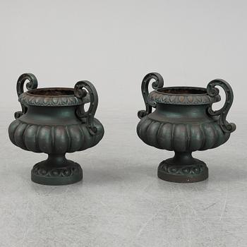 A 20th Century pair of cast iron flower pots.