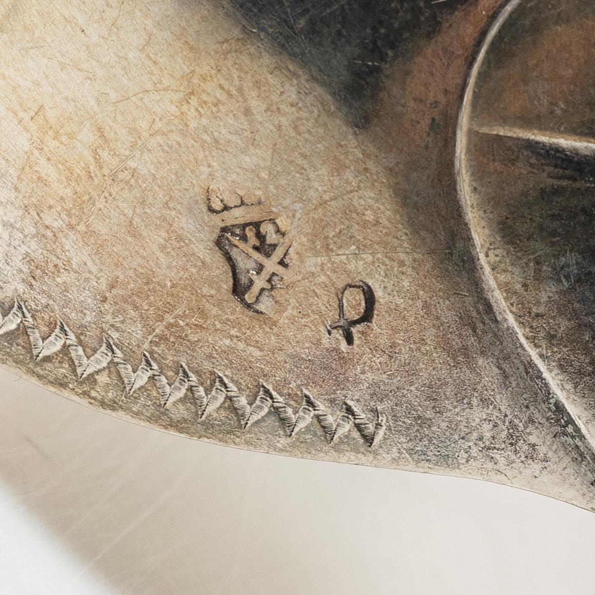Two silver serving spoons with pseudo-marks, around the year 1900.
