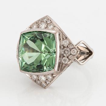 An 18K white gold ring set with a faceted tourmaline and round brilliant- and eight-cut diamonds.