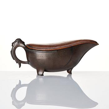 A Japanese bronze ewer with a scultpured wooden cover, Edo period (1603-1868), signed.