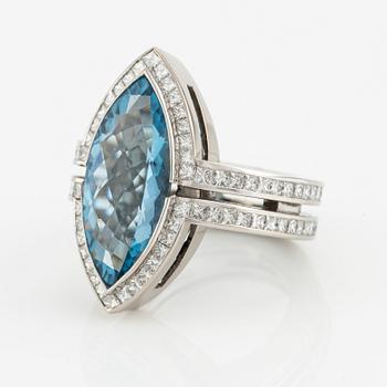 An 18K white gold Gaudy ring set with a faceted aquamarine and princess-cut diamonds.