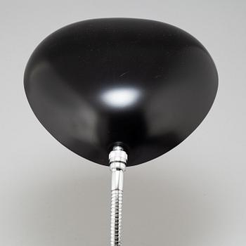 A 'Cobra' table lamp by Greta Magnusson Grossman, Gubi.