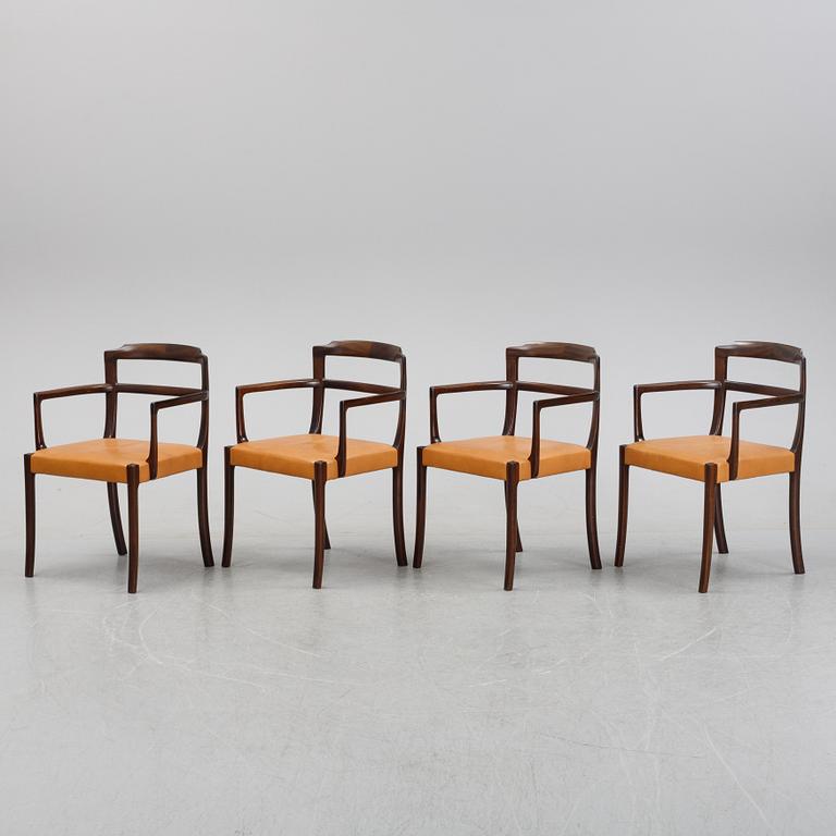 A set of four black stained beech tree arm chairs with leather upholstery, second half of the 20th century.