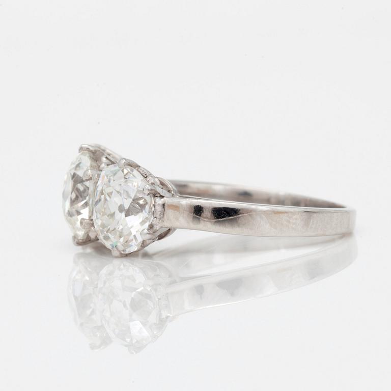 A three stone old mine and old cushion cut diamond ring. Total carat weight 4.01cts.